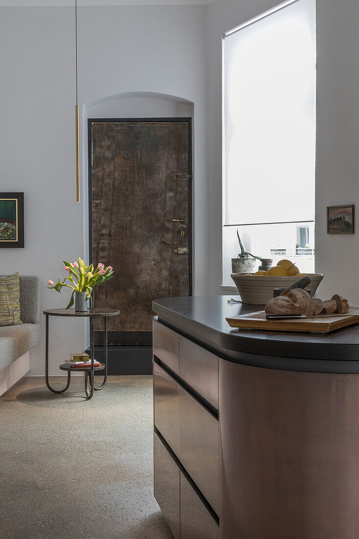 Kitchen island in front of a rustic metal door