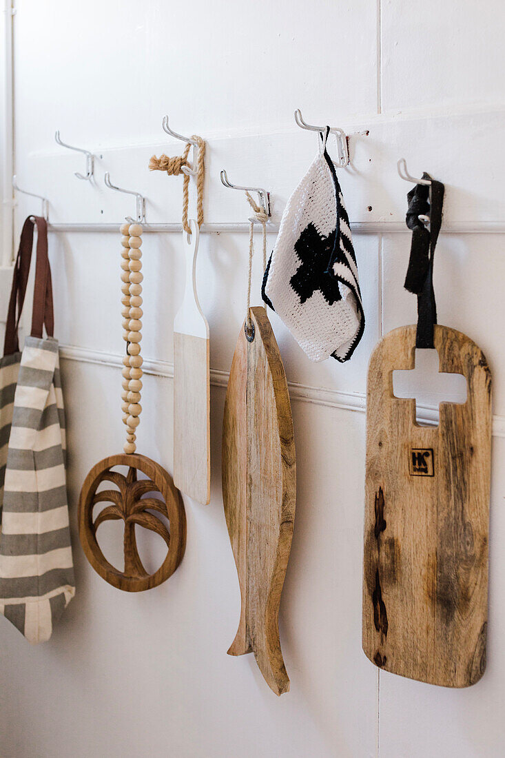 Wooden chopping boards, decoration and fabric bag on wall hooks