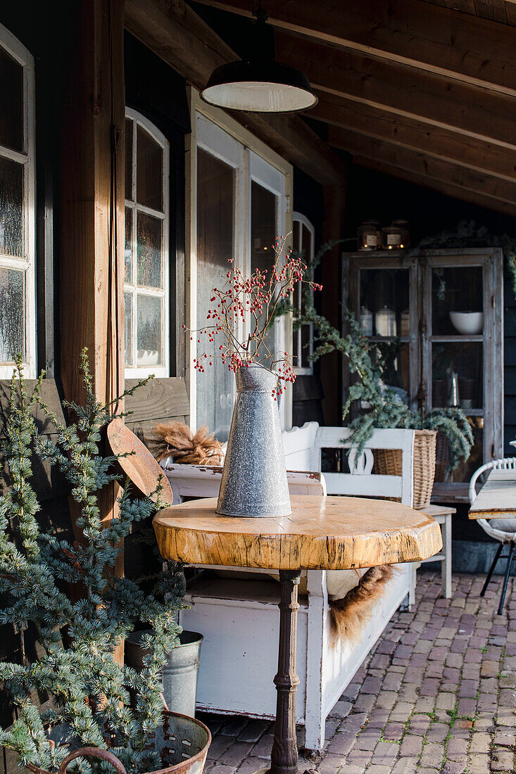 Cosy terrace with white bench and decorative vase