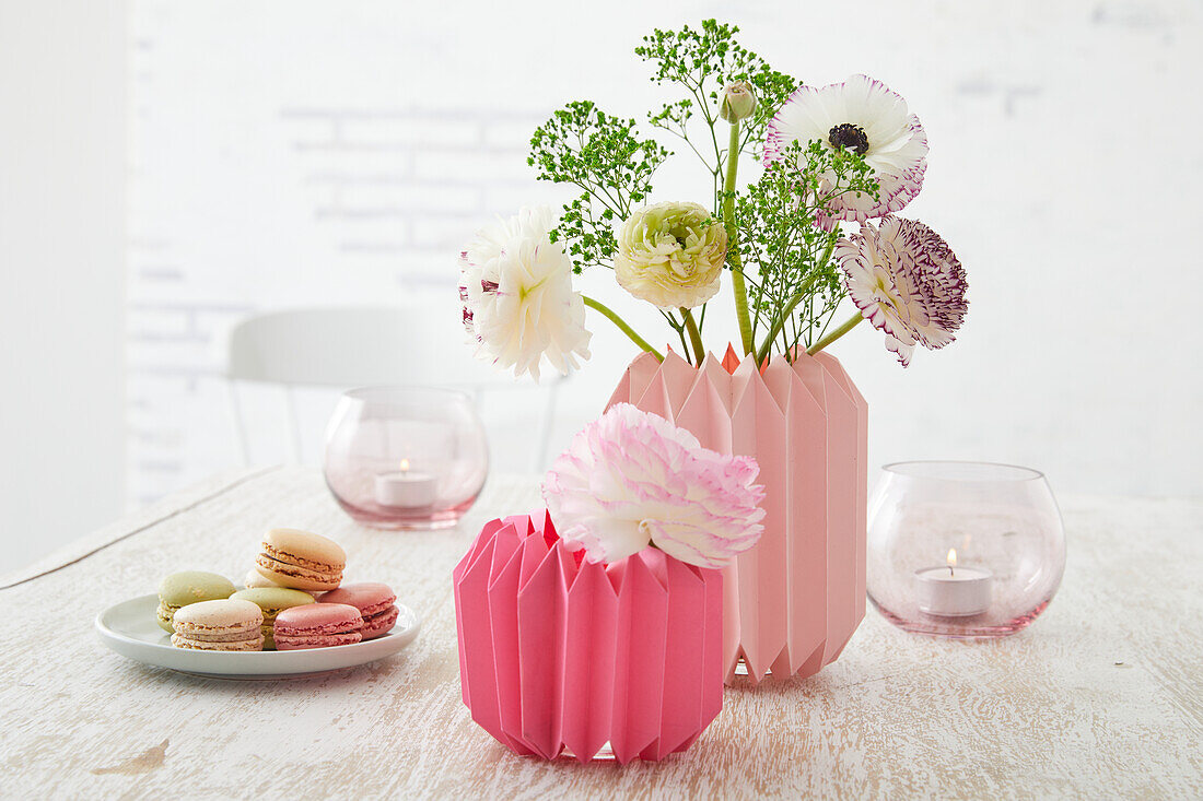 DIY vases made from folded paper with delicate spring flowers