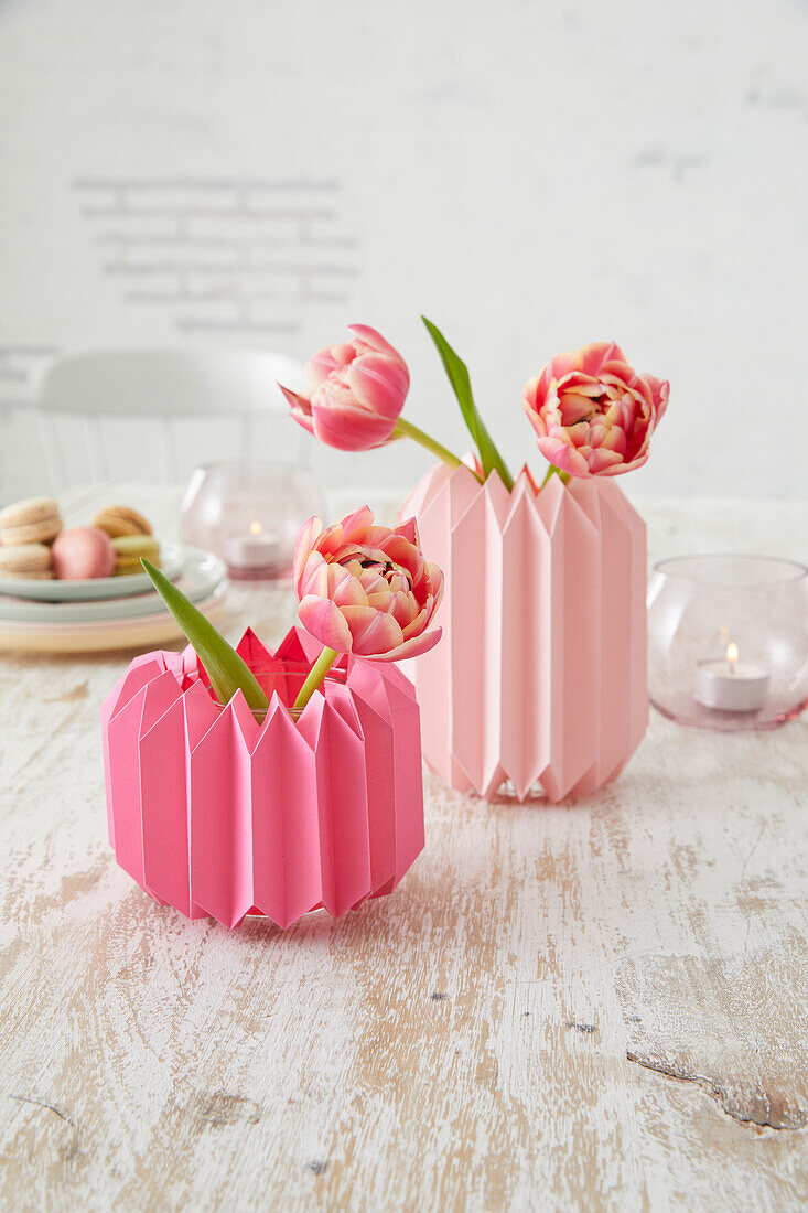 DIY folding vases with tulips on a wooden table