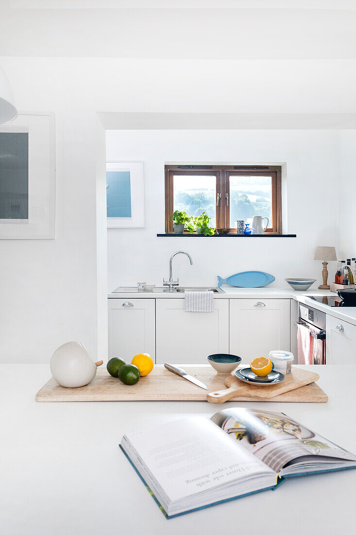 Bright kitchen with chopping boards and fresh fruit on the worktop