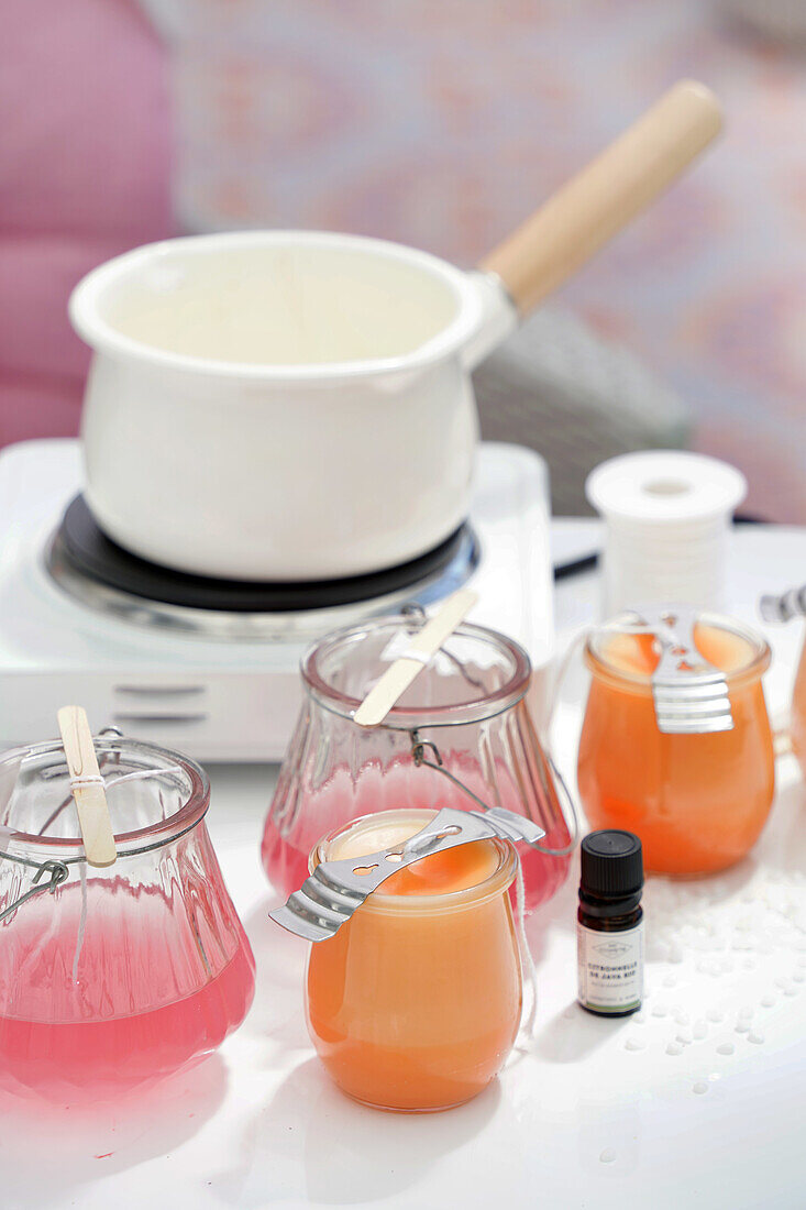 Accessories and ingredients for making scented candles on a table