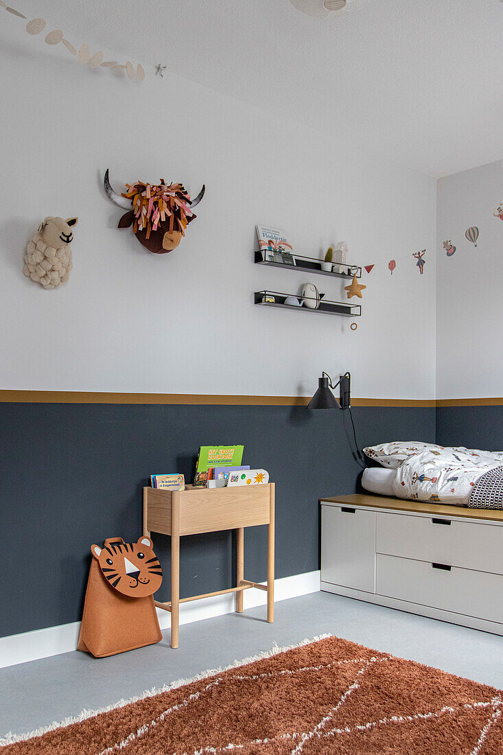 Children's room with wall decorations, bookshelf and tiger storage bag