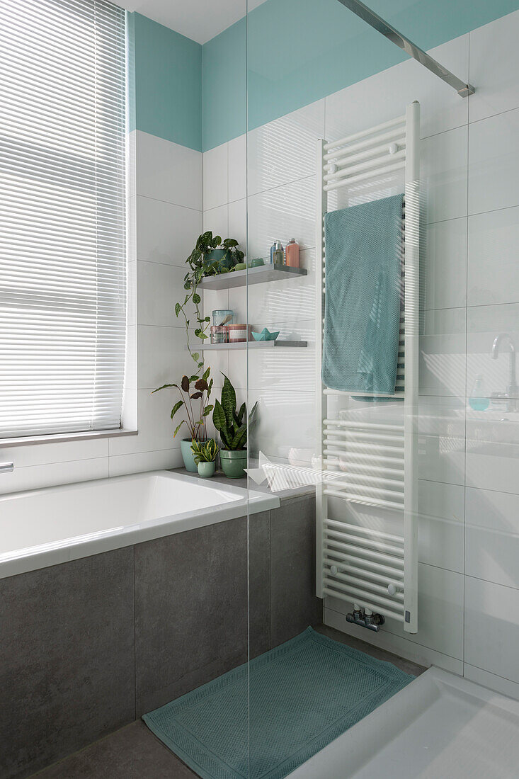 Modern bathroom with plants and radiator in a minimalist design