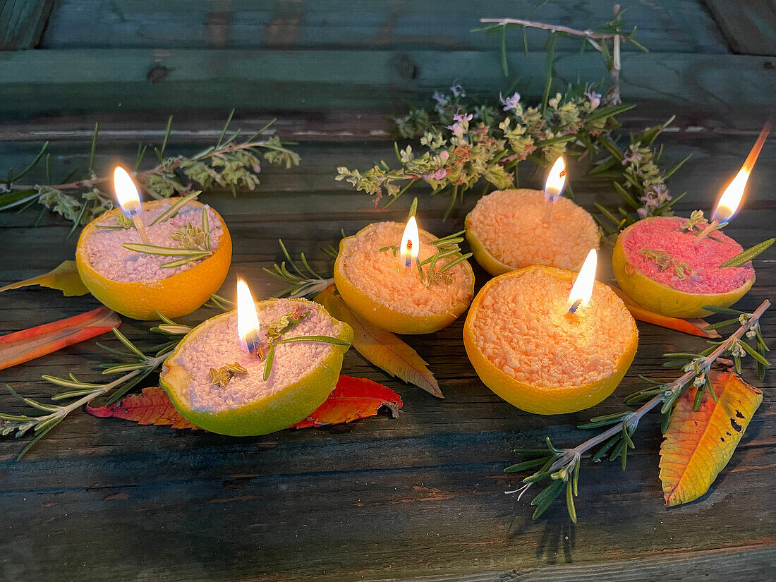 DIY candles with rosemary in lemon peel