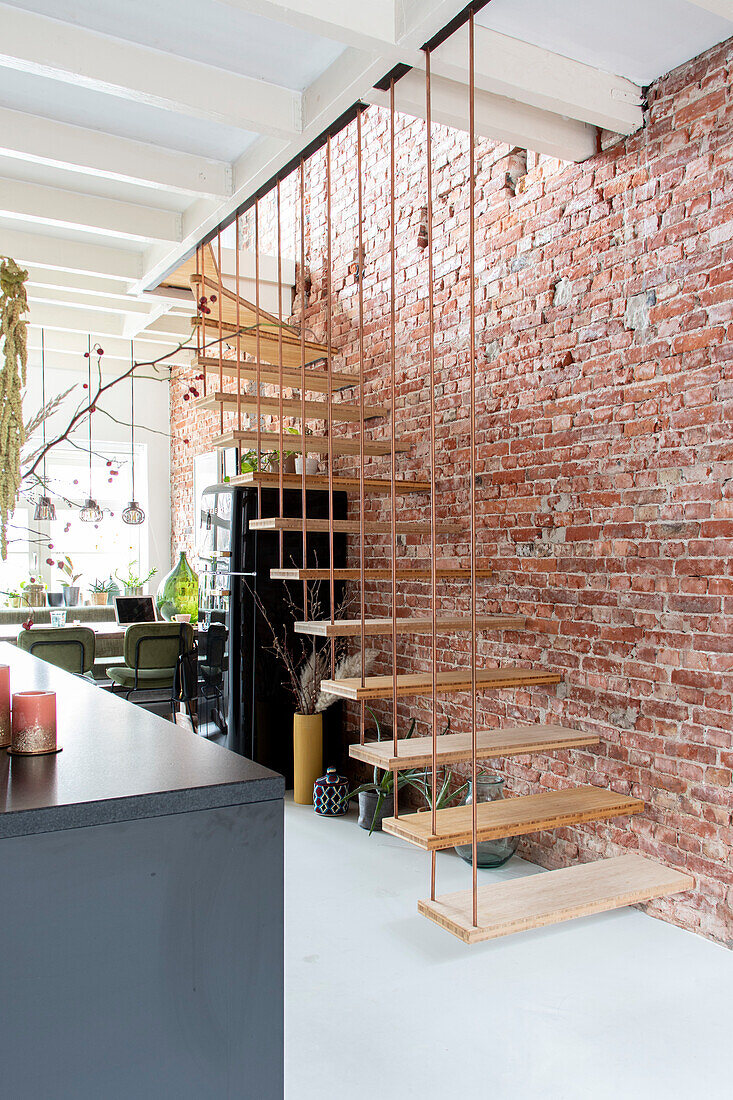 Hanging staircase on red brick wall