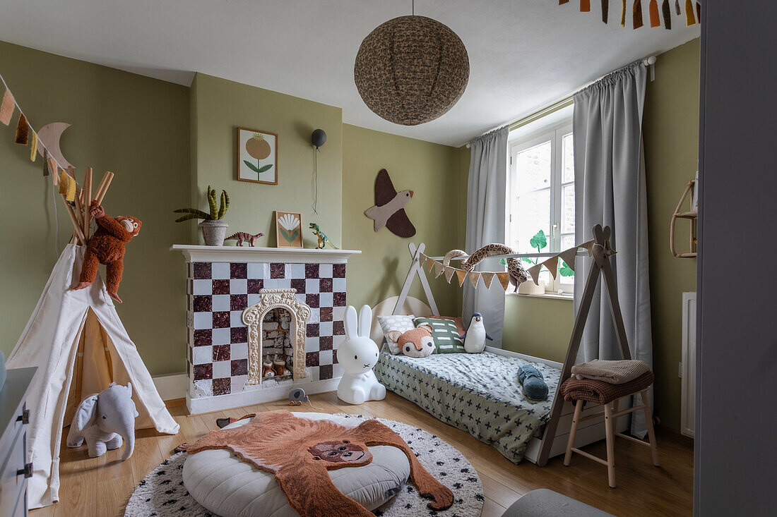 Children's room with fireplace, teepee tent and animal toys