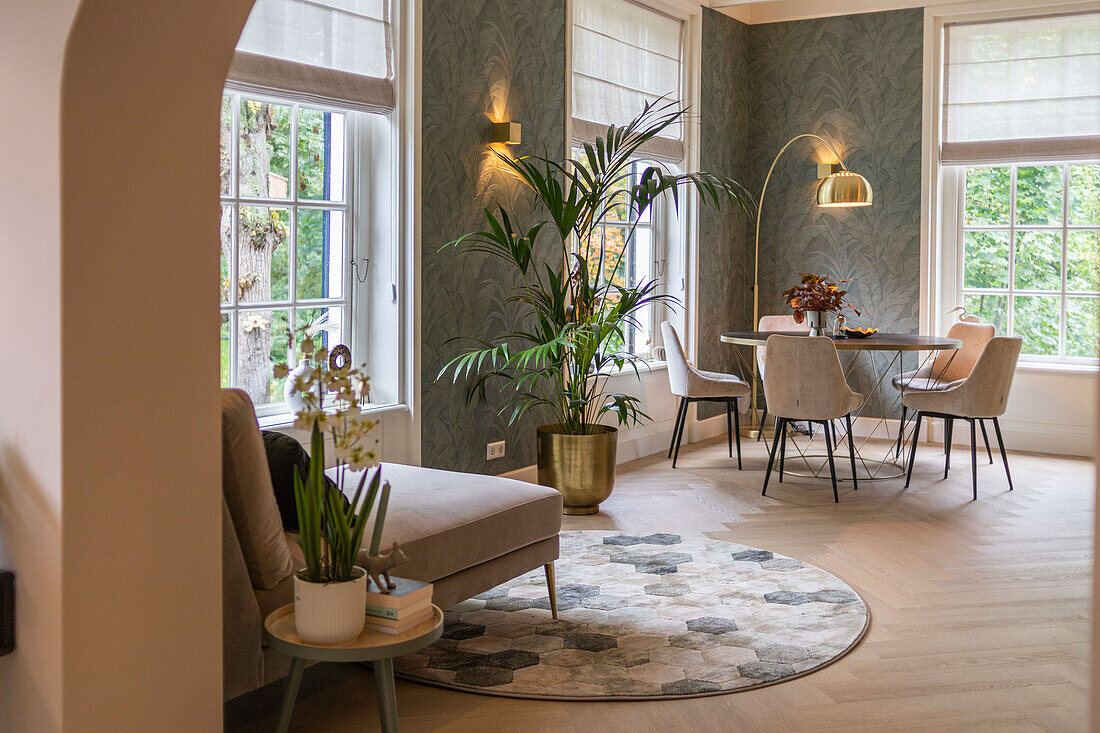 Cozy dining area and reading corner with large windows and indoor plants