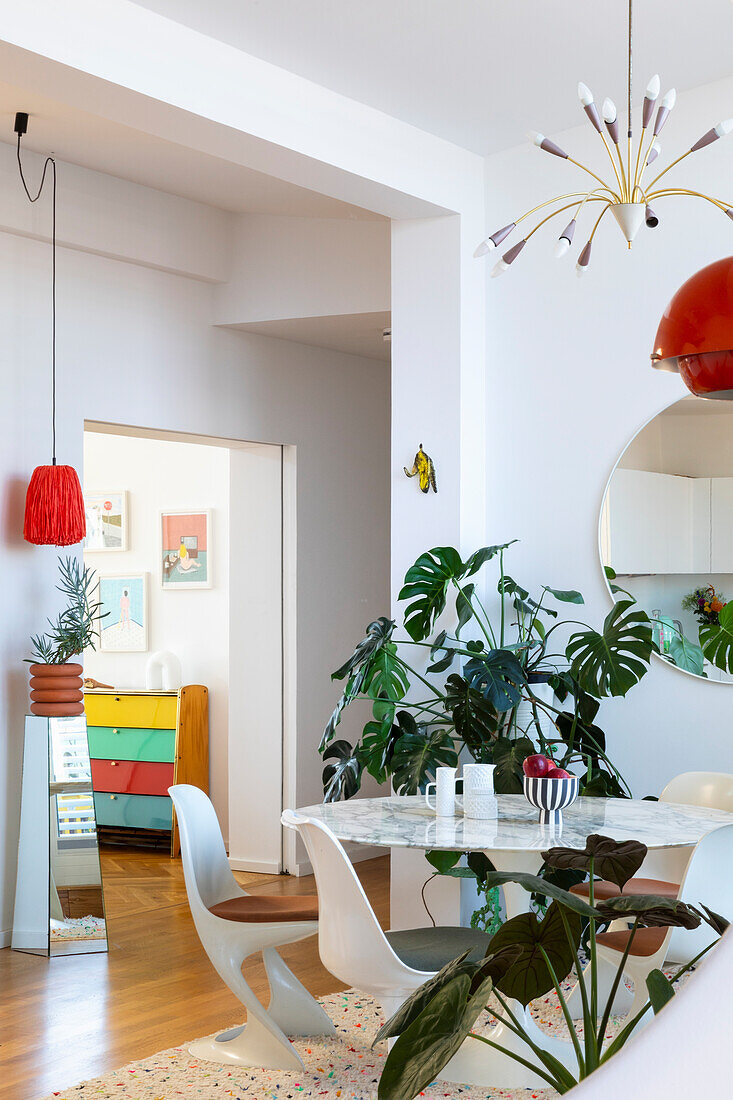 Dining room with white marble table, plants and retro-accents