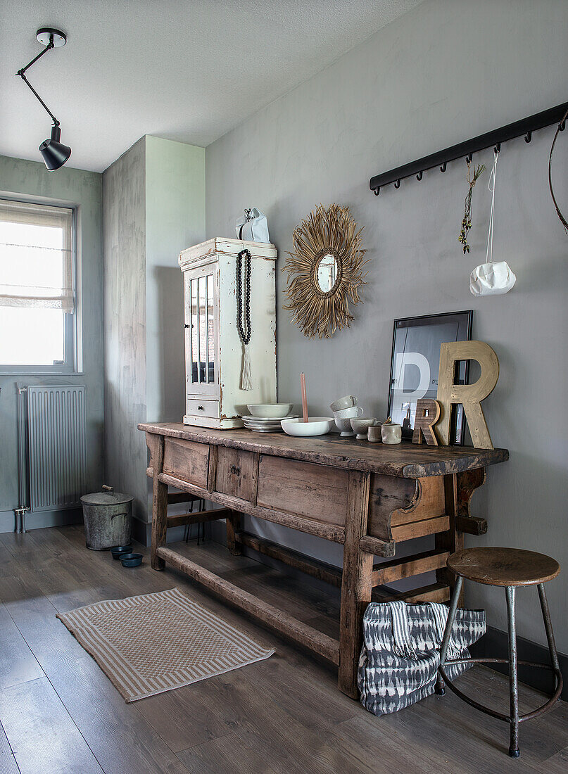 Rustic hallway with wooden console, stool and decorations