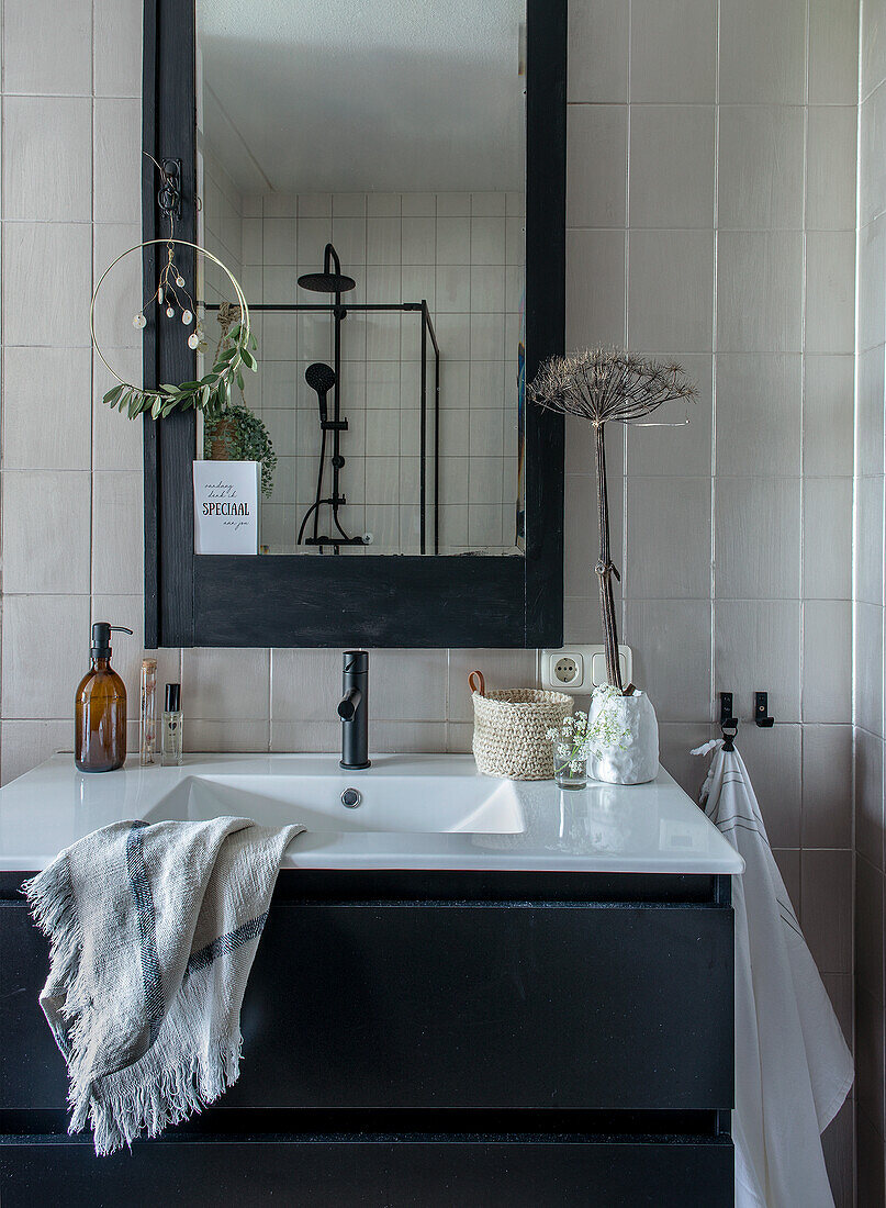 Black and white bathroom with modern vanity and mirror