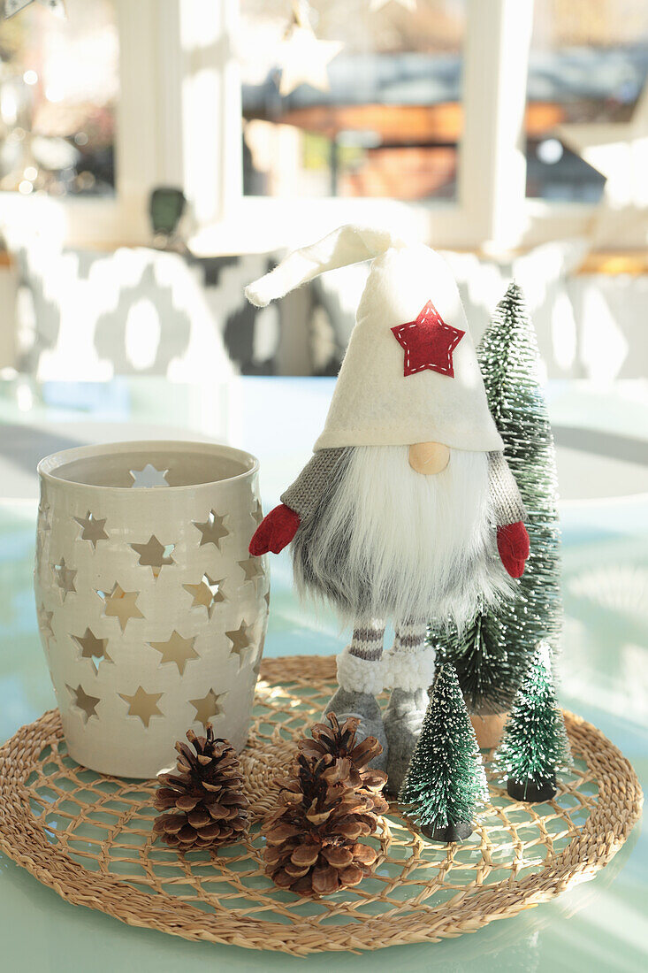 Christmas decoration with gnome, cones and ceramic lantern