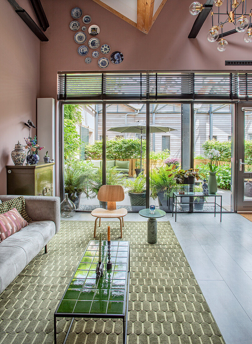 Large living room with floor-to-ceiling windows and view of the terrace