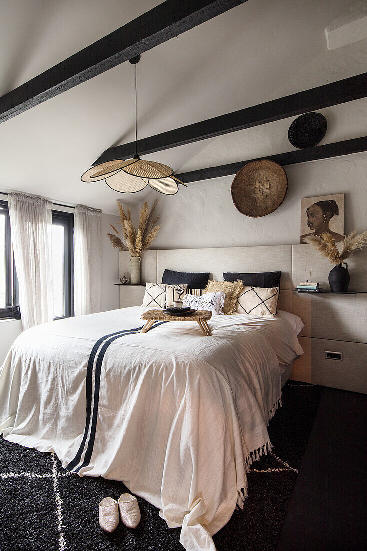 Bedroom with dark wooden beams and ethnic-style decoration