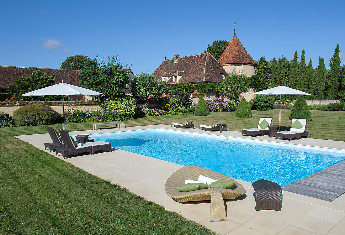 Pool with elegant loungers in the garden