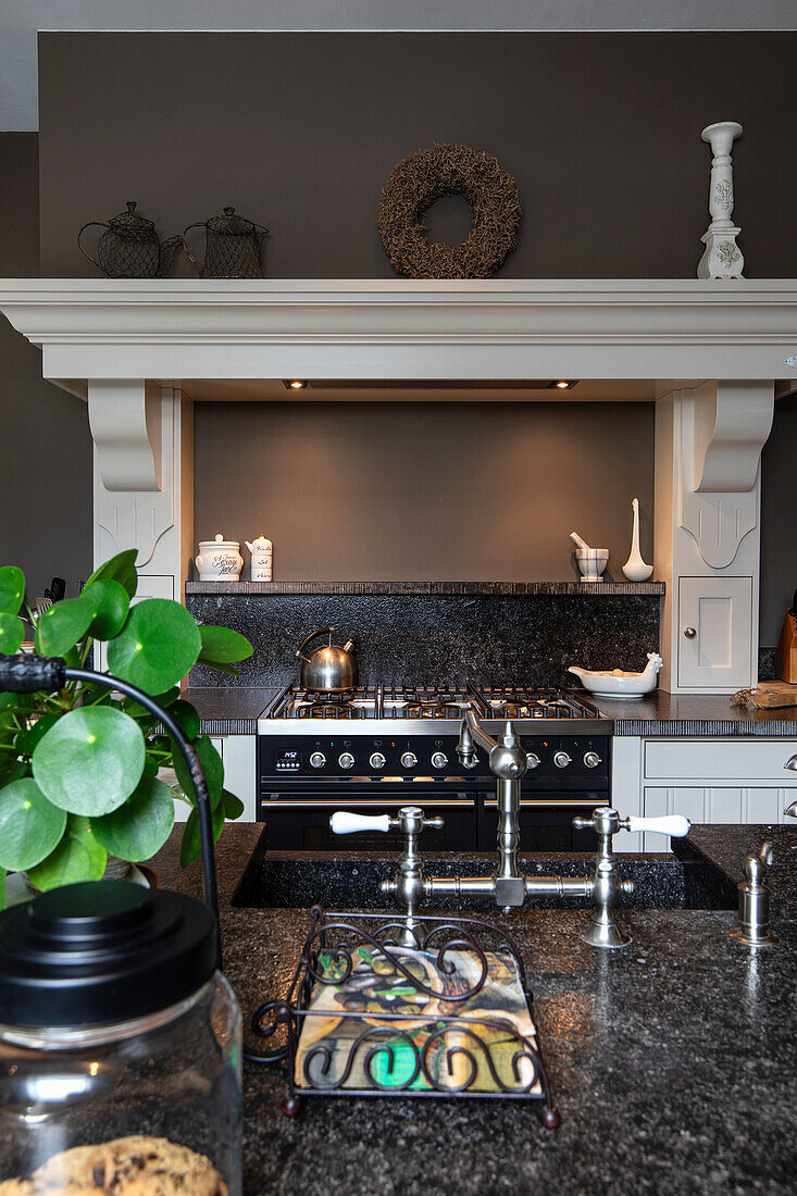 Country kitchen with gas hob, granite worktop and wall decor