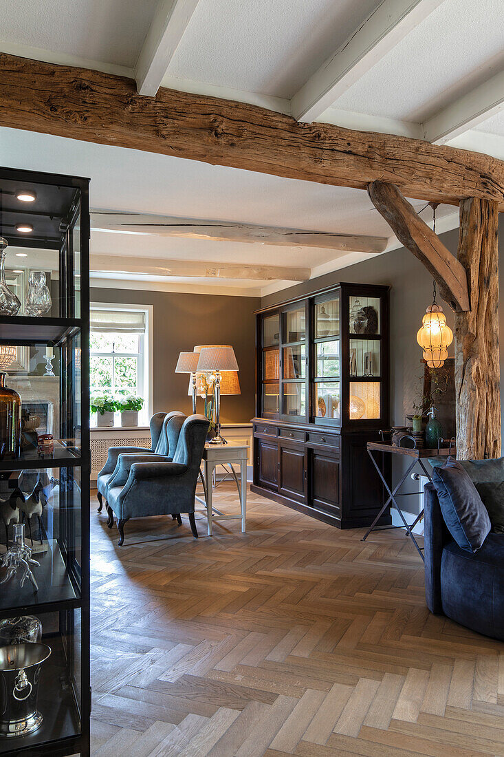 Rustic living room with exposed wooden beams and herringbone parquet flooring