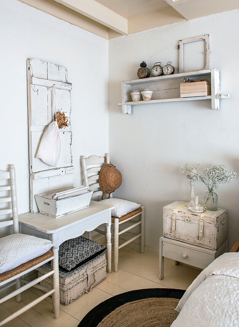 White, vintage-inspired bedroom with shabby chic furniture and decorative items