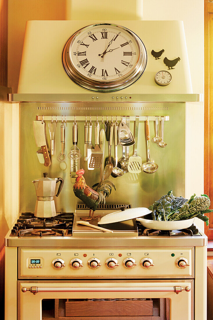 Vintage kitchen cooker with hanging shelf for cooking utensils and wall clock