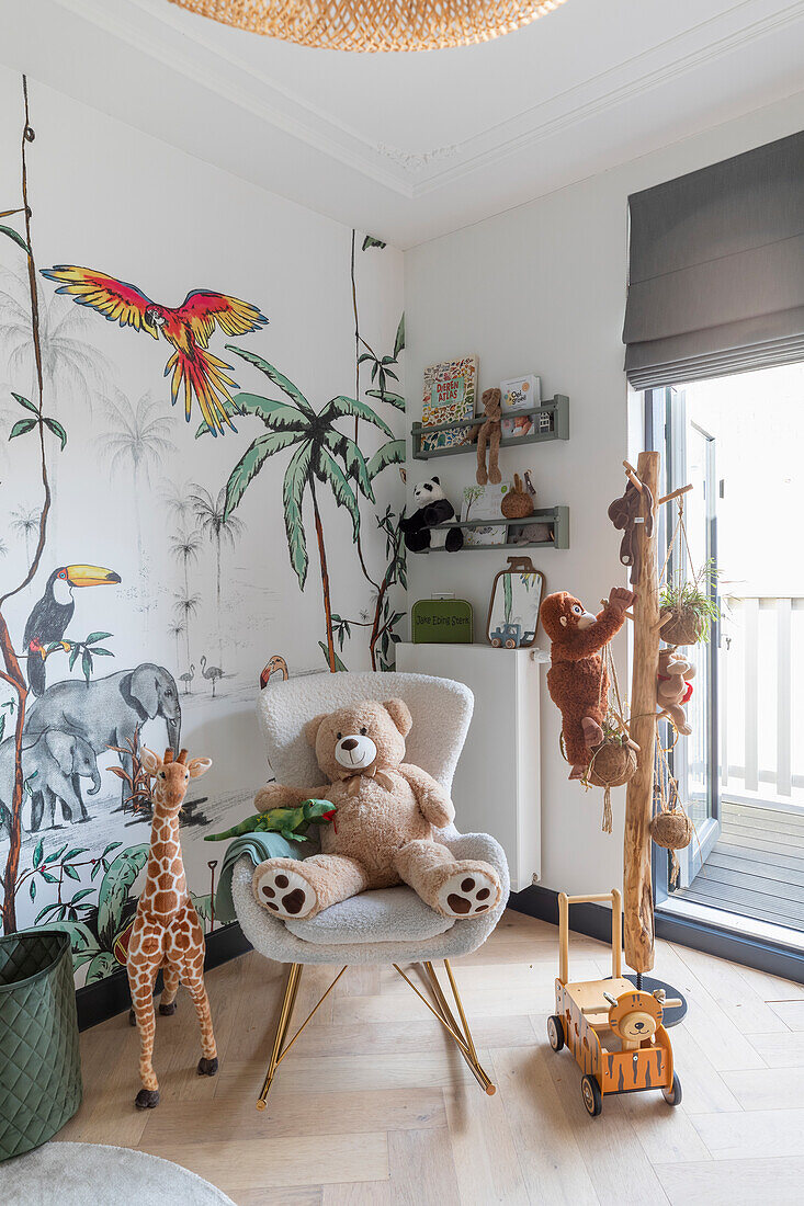 Children's room with wall painting of jungle animals and plush toys