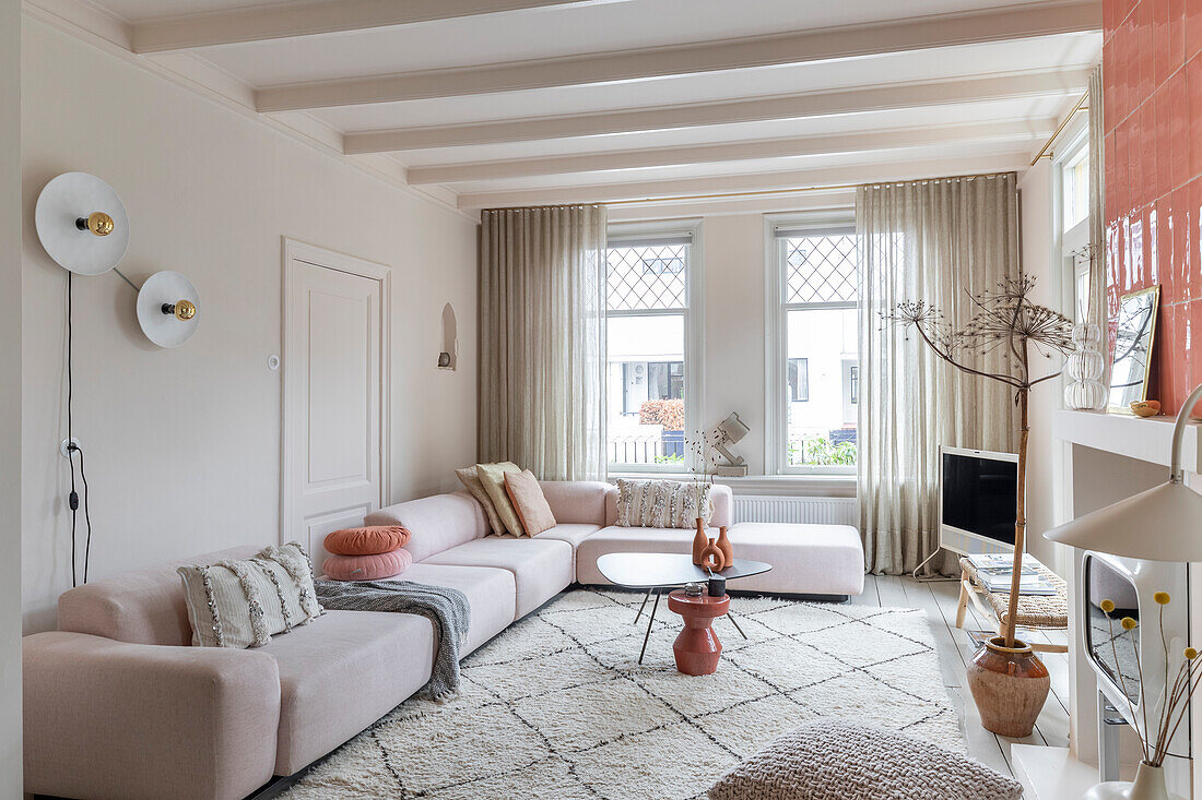 Bright living room with corner sofa and geometric rug