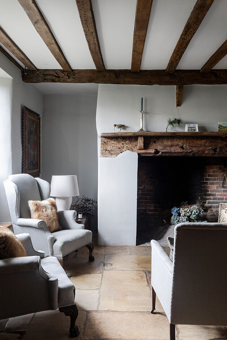 Living room with rustic fireplace and wooden beamed ceiling