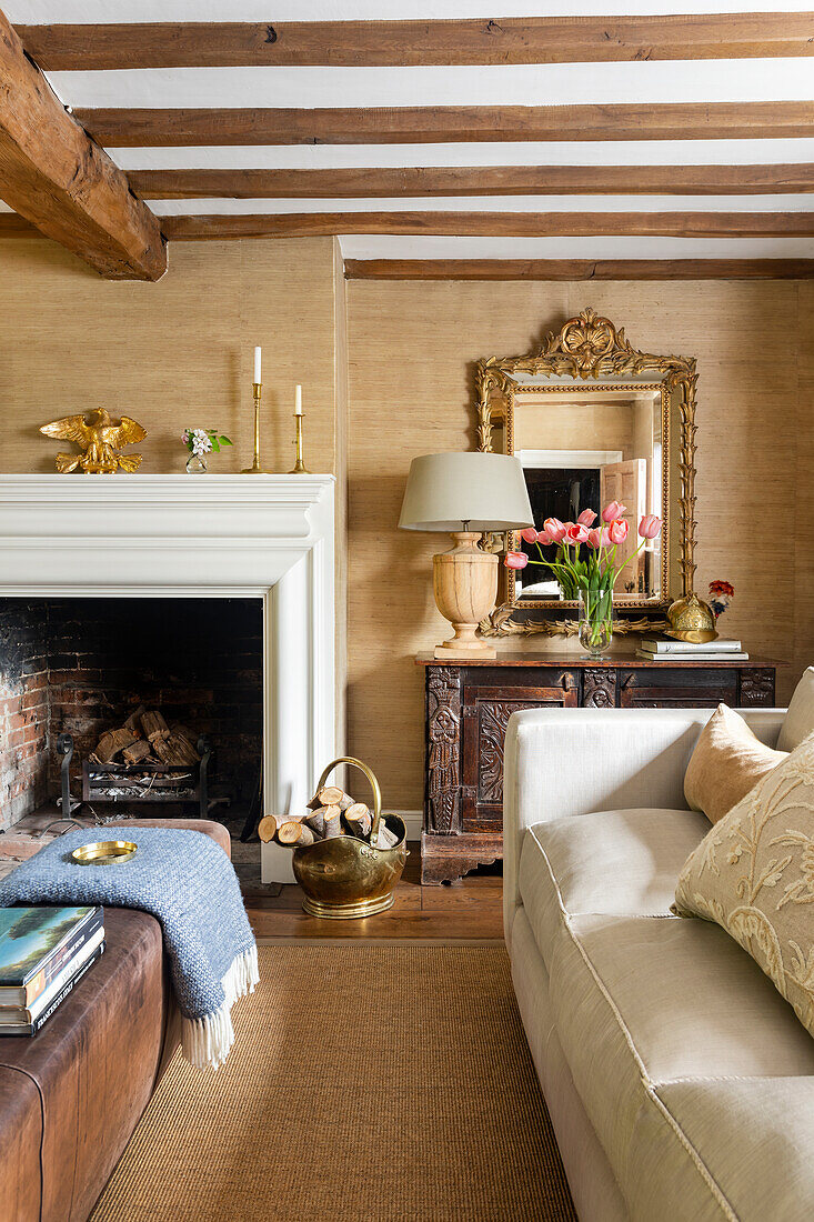 Living room with beamed ceiling, fireplace and antique mirror