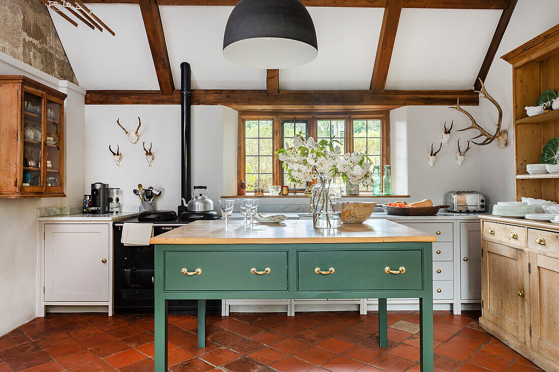 Country kitchen with green kitchen island and rustic wood decor