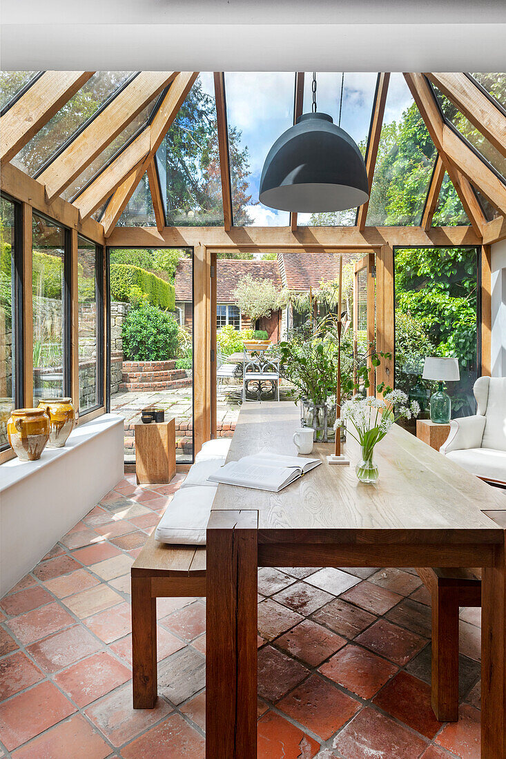 Dining room in the conservatory with large table and terracotta tiles