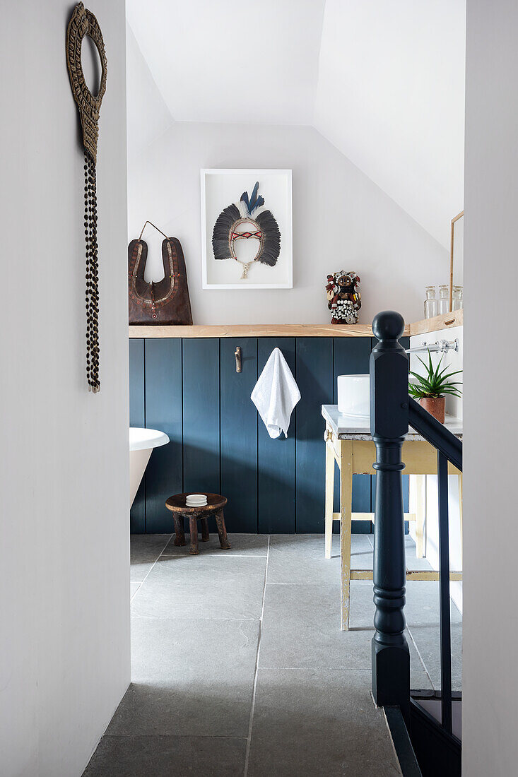 Modern bathroom with blue cupboard doors and decorations