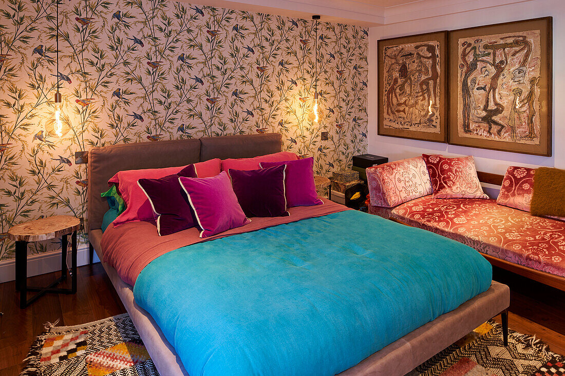 Guest room with double bed and daybed, wallpaper and pictures on the walls