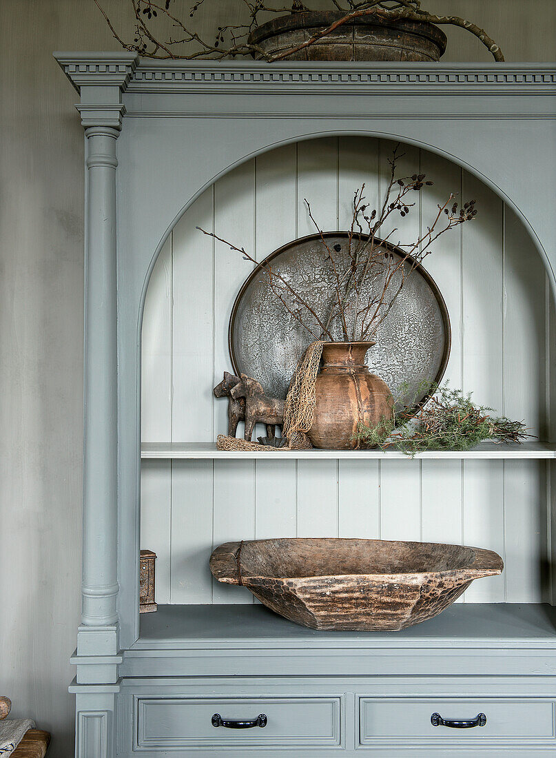 Decorative cabinet with rustic accessories and wooden bowl