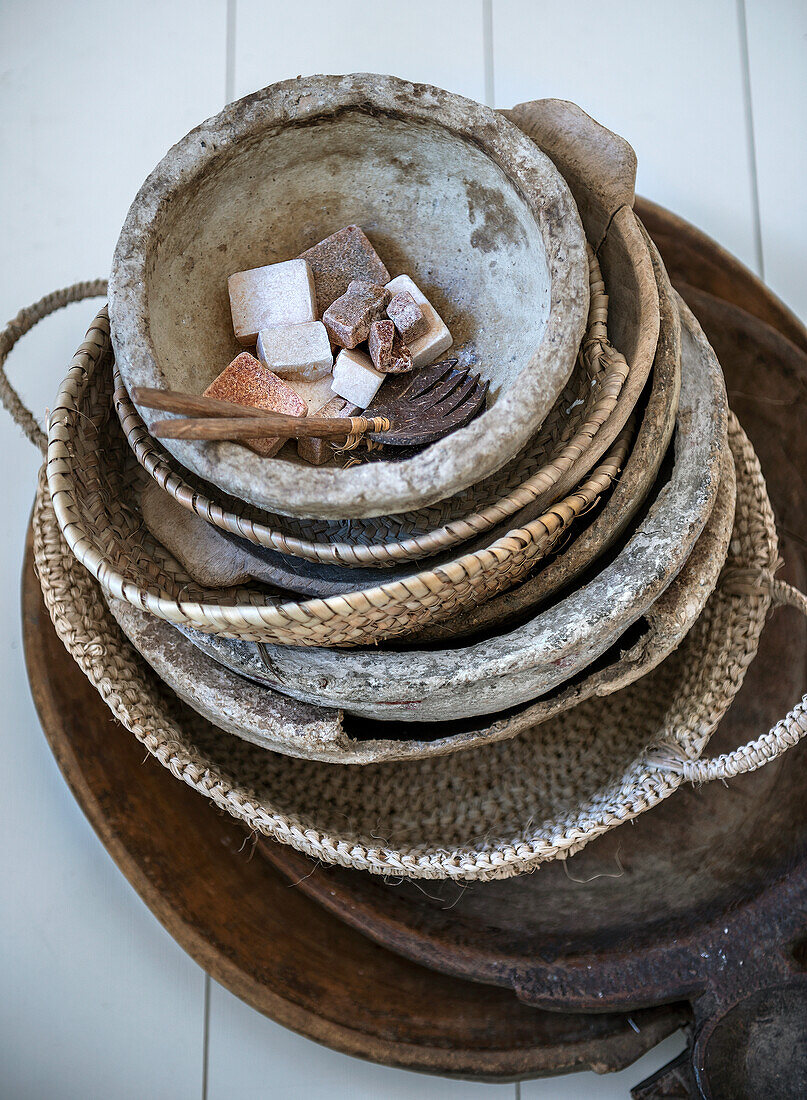 Stack of various baskets and bowls made from natural materials