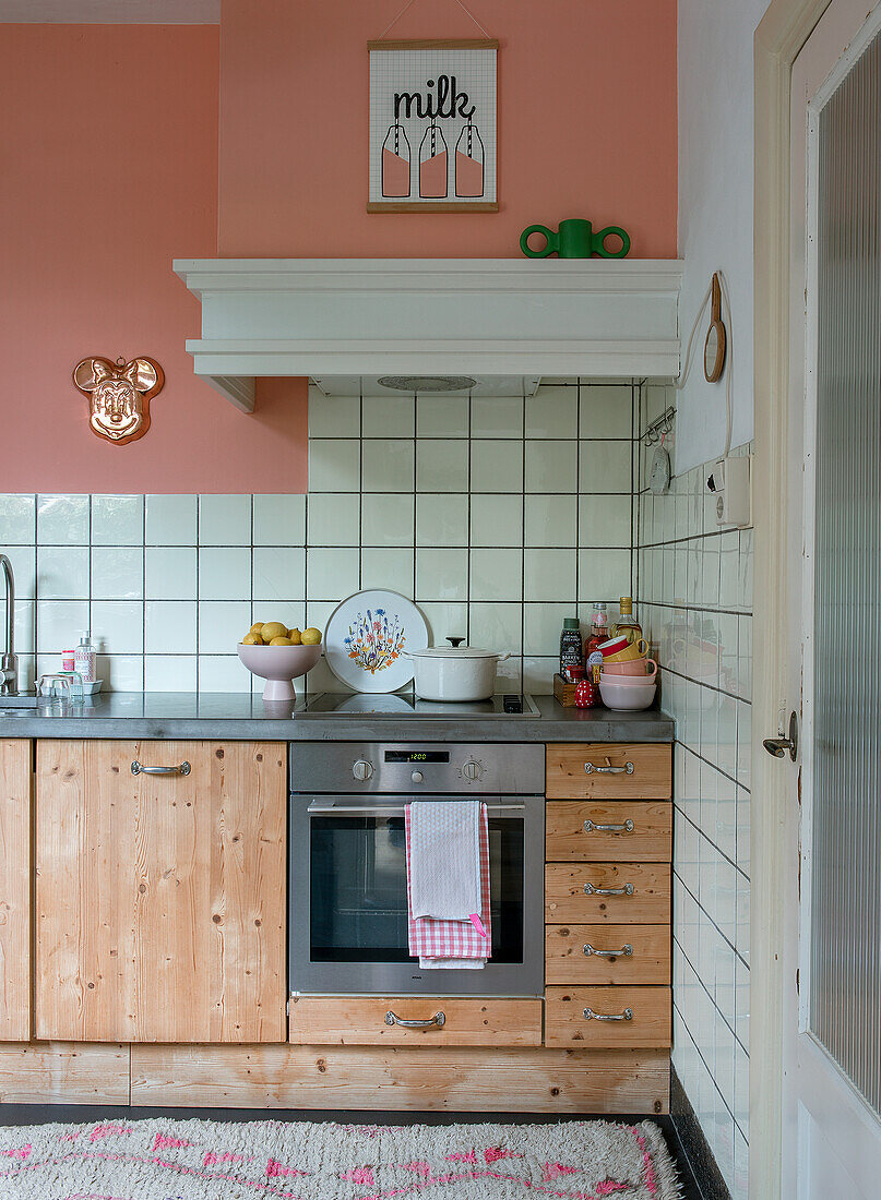 Country-style kitchen with wooden cabinets and pastel-coloured walls