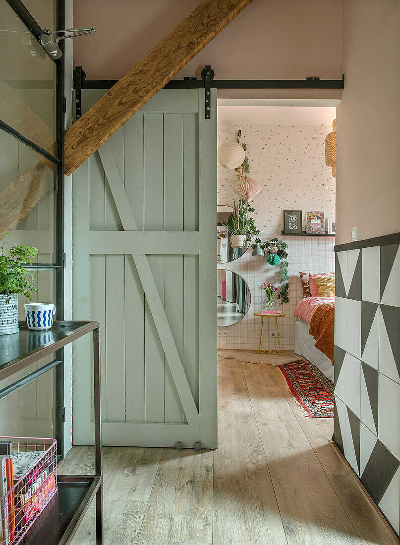 Wooden sliding door opens into a playful bedroom