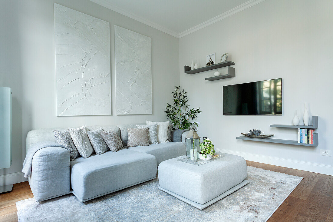 Modern living room with grey sofa landscape and wall-mounted TV