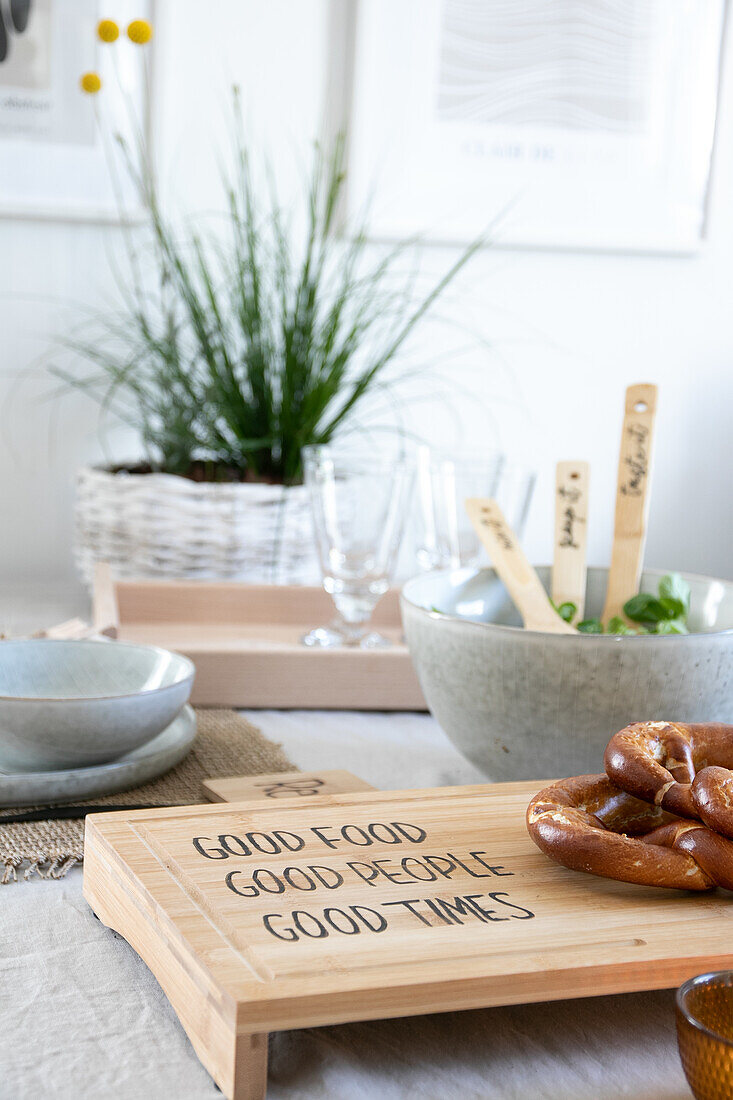 Breakfast table with personalised chopping board and pretzels