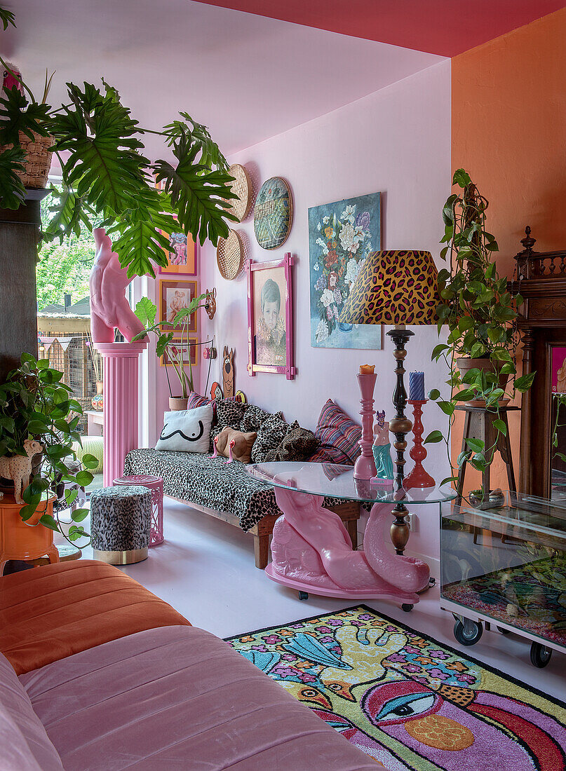 Colorful living room with leopard sofa, lots of plants and works of art