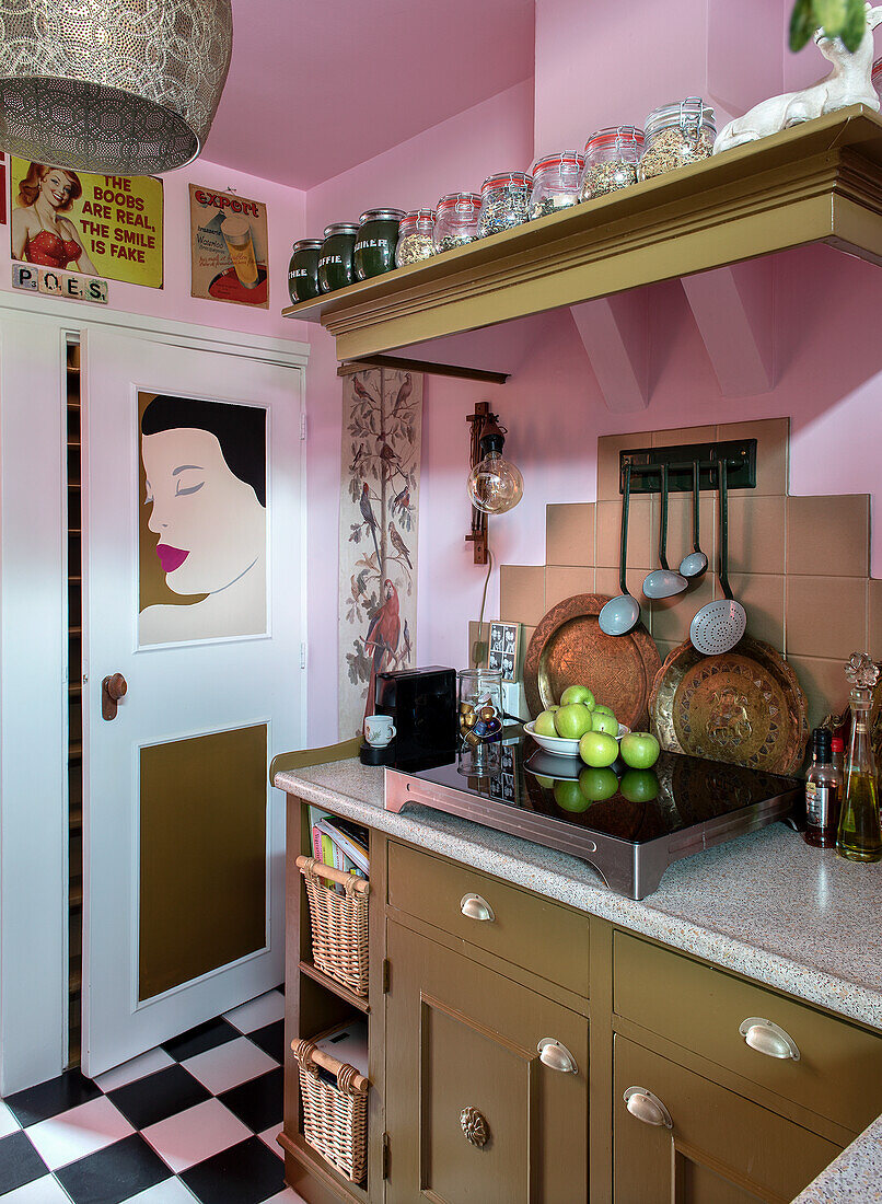 Retro kitchen with pink walls and black and white chequered floor