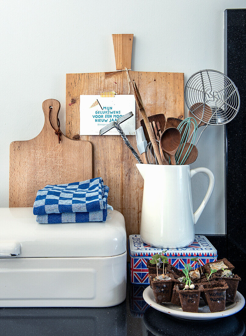 Wooden chopping boards, kitchen utensils and sprouts in the kitchen