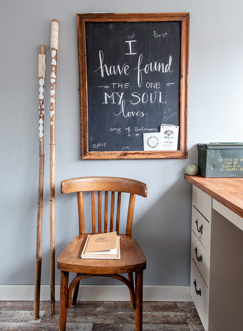 Wooden chair in front of chalkboard with love quote in study