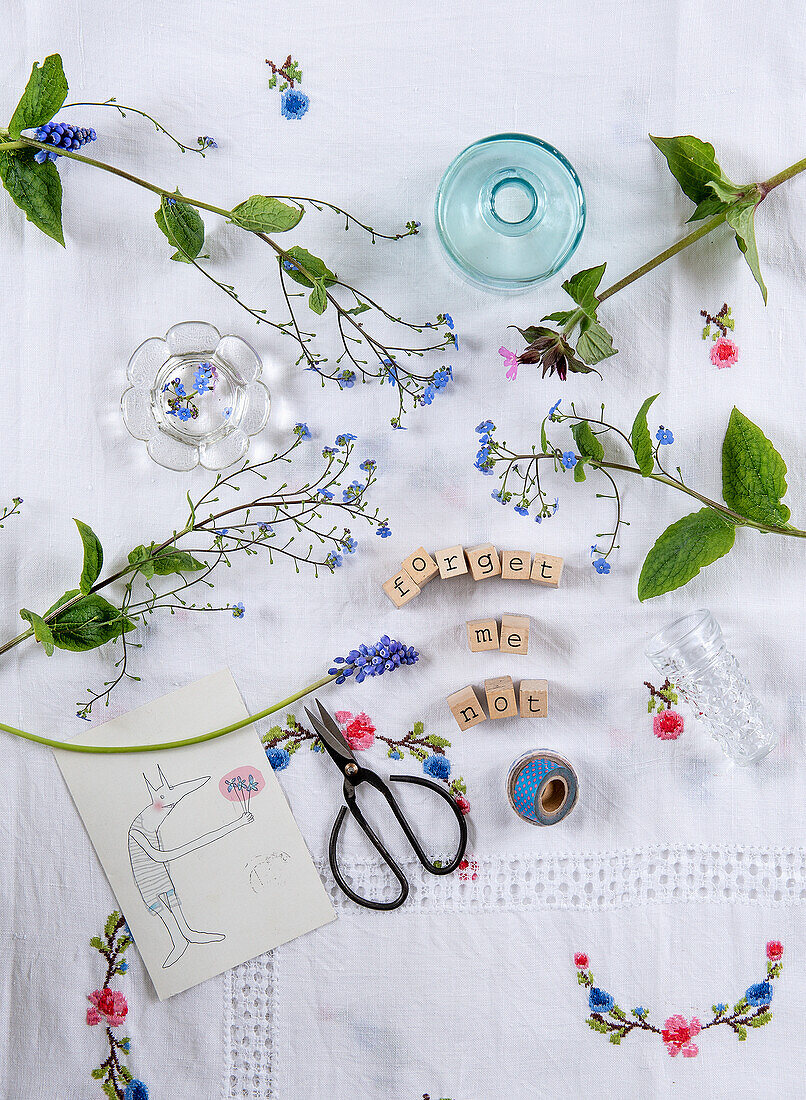 Decorative embroidery with forget-me-nots, drawing and Scrabble letters