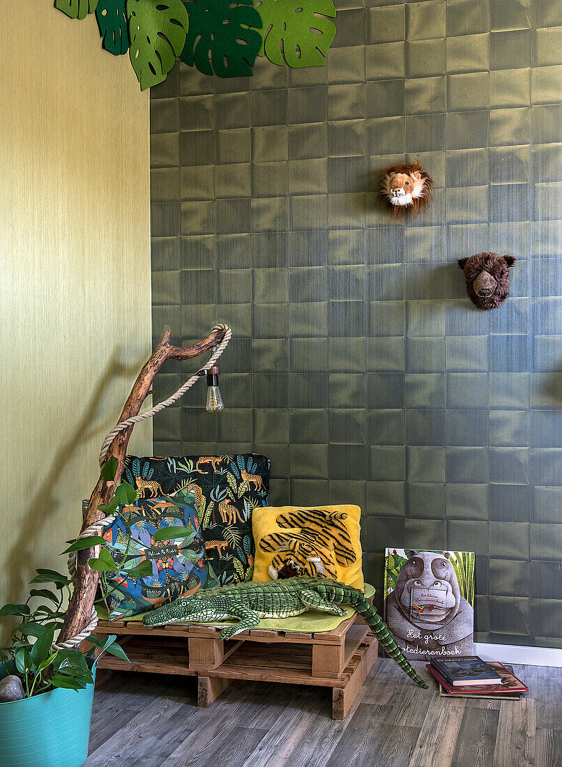 Corner in children's room with jungle theme and wooden pallet bench seat