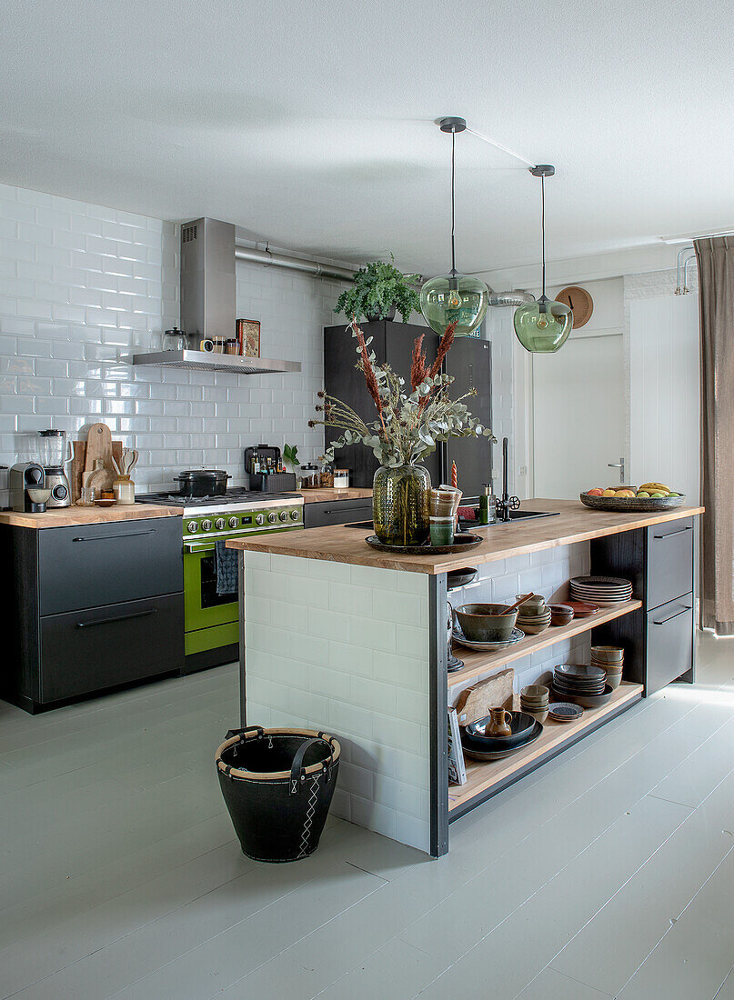 Modern kitchen with green gas hob and cooking island with open shelves