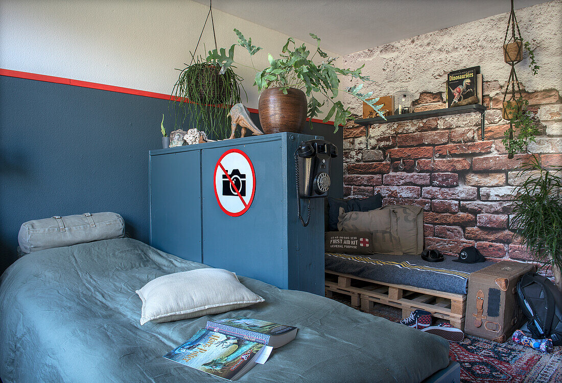 Teenage room with bed, locker, brick wallpaper and pallet bench seat