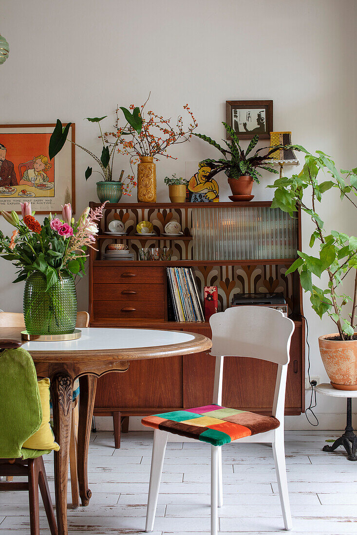 Dining room with vintage furniture and lots of plants