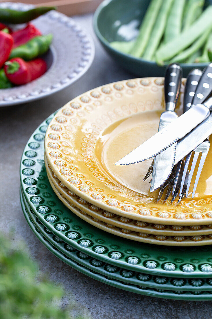 Colourful ceramic plates with cutlery