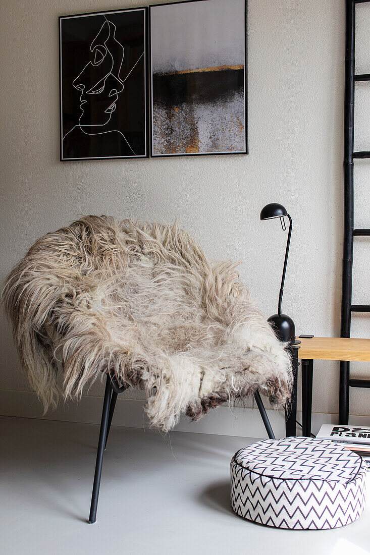 Chair with sheepskin and modern wall art