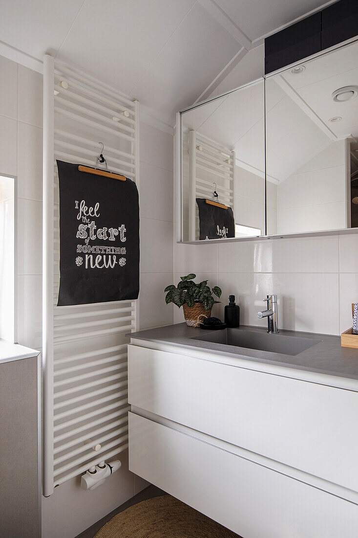 Modern bathroom with floating washbasin and towel radiator